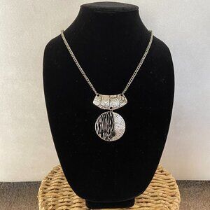Silver tone statement necklace with large round pendant